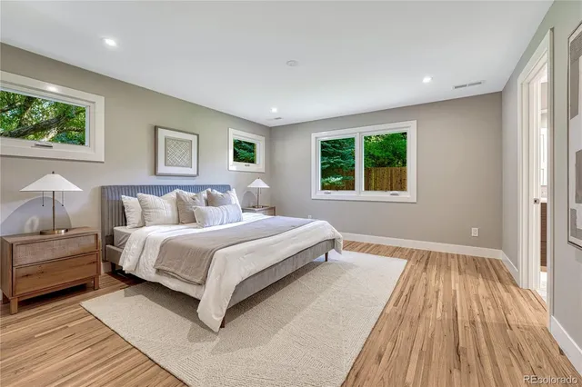 a spacious bedroom with a large bed and a window