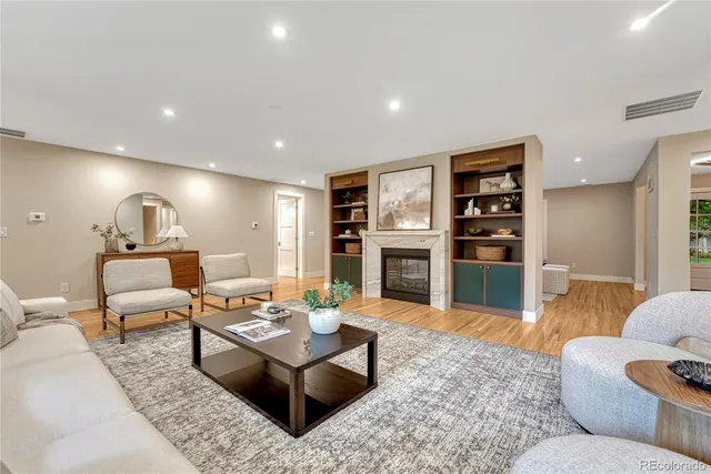 a living room with furniture and a wooden floor