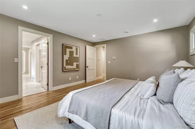 a bedroom with a large bed and a chandelier