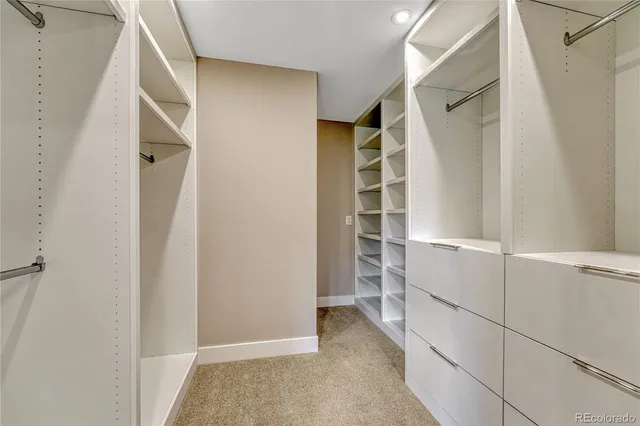 a view of walk in closet with empty racks