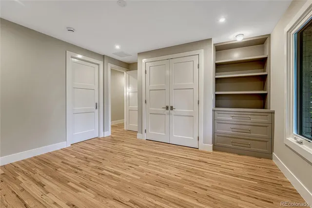 a view of an empty room with wooden floor