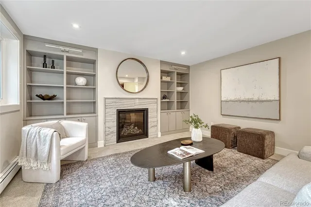 a living room with furniture a rug and a fireplace