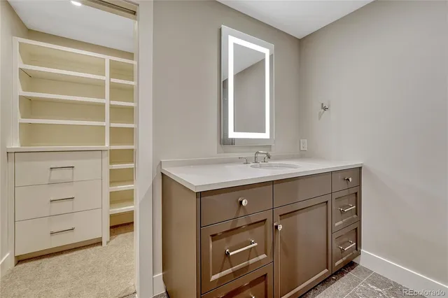 a bathroom with a sink vanity and a mirror