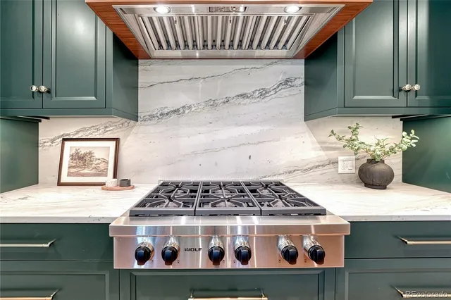 a kitchen with stove and cabinets