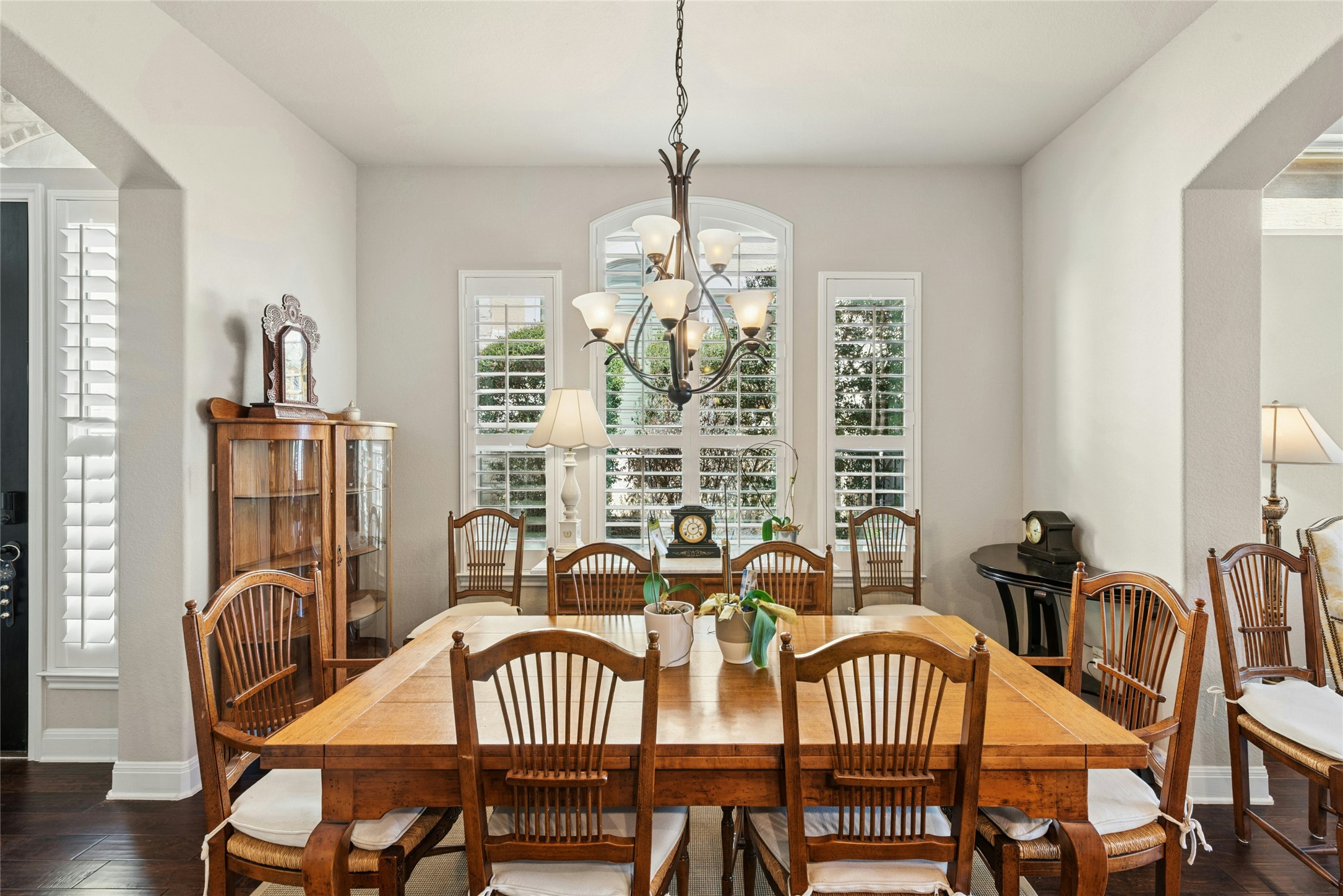 116 Evolutions Path Lakeway, TX 78738 - Photo 7 of 34 Dining room featuring dark wood-style floors, arched walkways, and a chandelier