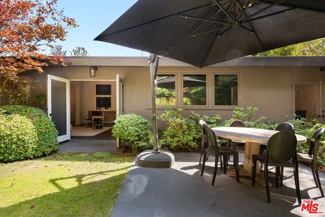 a view of a patio with chairs and plants