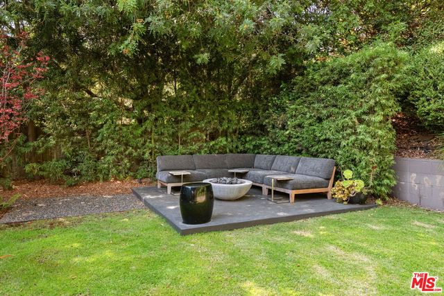 a view of a swimming pool with a table and chairs under an umbrella