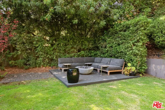 a view of a swimming pool with a table and chairs under an umbrella