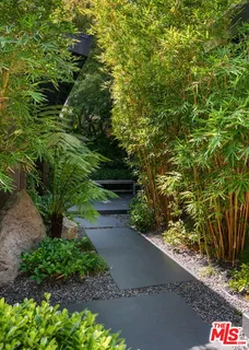 a living room with furniture and floor to ceiling windows