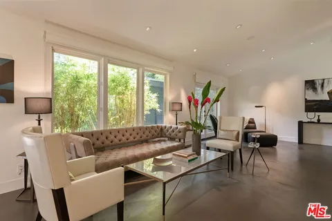 a living room with furniture and a potted plant
