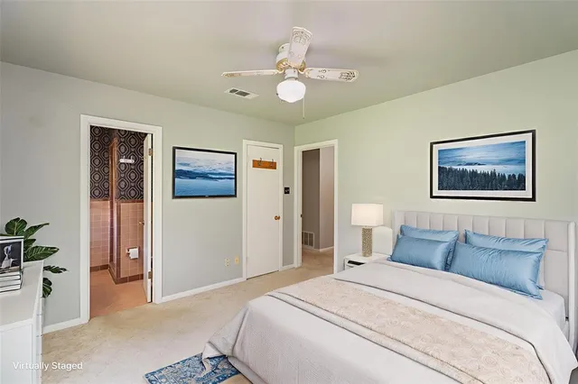 a bedroom with a large bed and a chandelier