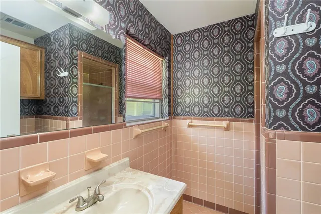 a bathroom with a bathtub and shower