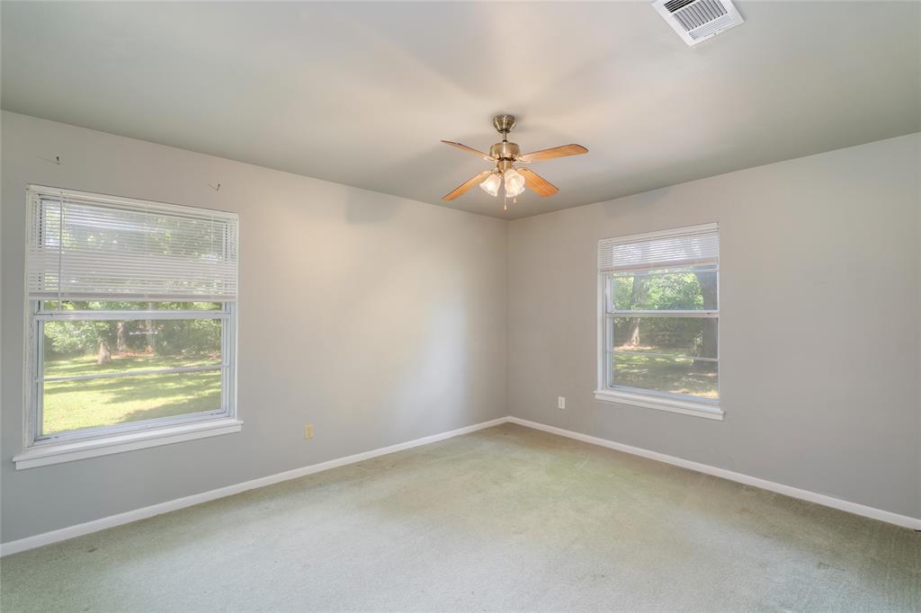 6000 Forrest Lane Canton, TX 75103 - Photo 17 of 37 an empty room with a window and a ceiling fan