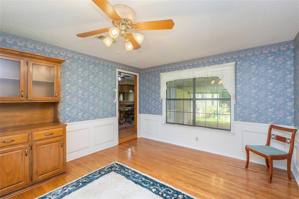 6000 Forrest Lane Canton, TX 75103 - Photo 21 of 37 a view of a livingroom with wooden floor and a kitchen space