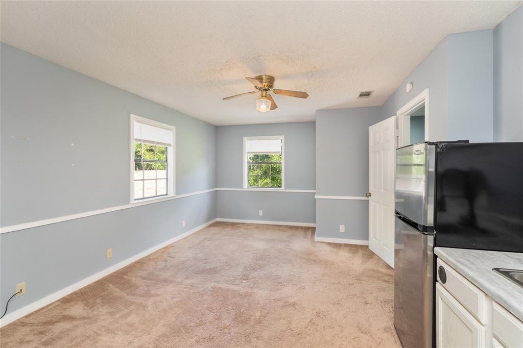 6000 Forrest Lane Canton, TX 75103 - Photo 25 of 37 a view of a kitchen with a flat screen tv and windows