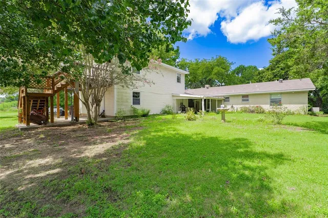 a view of house with backyard