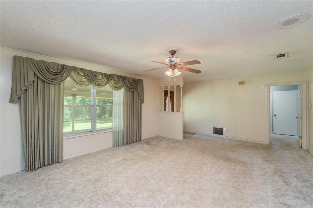 6000 Forrest Lane Canton, TX 75103 - Photo 3 of 37 an empty room with windows and chandelier fan