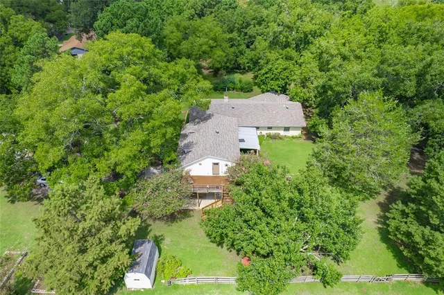 an aerial view of a house with yard and outdoor seating