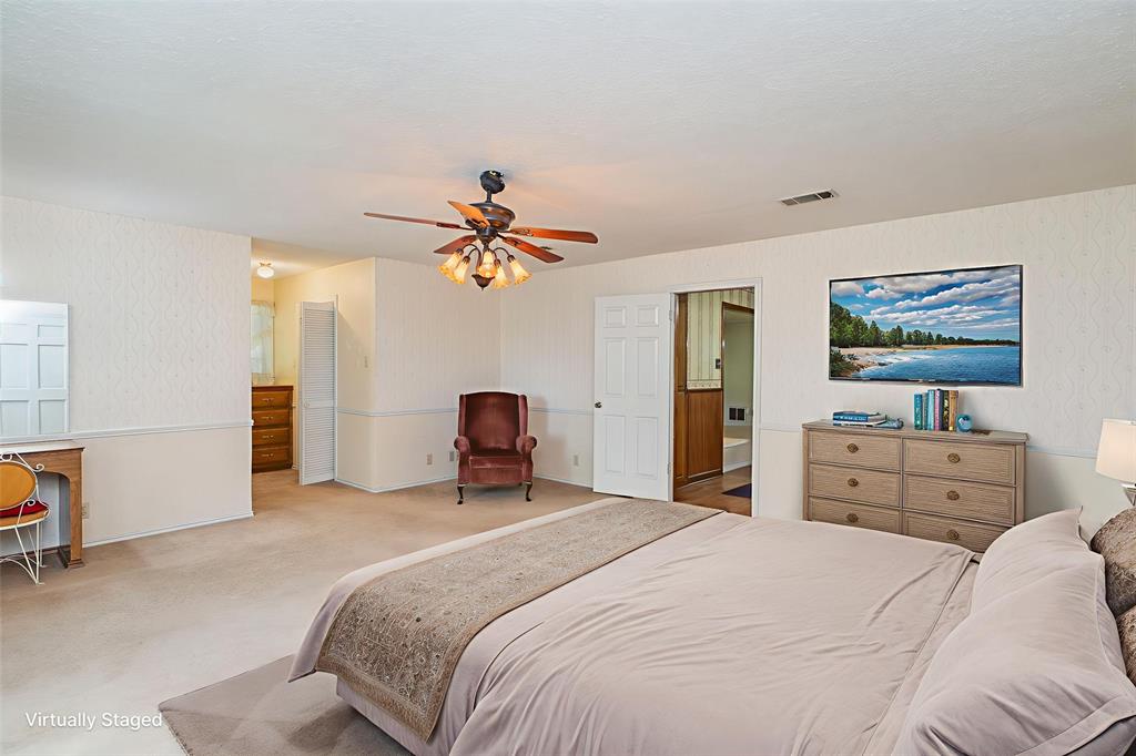 6000 Forrest Lane Canton, TX 75103 - Photo 10 of 37 a bedroom with a bed and a chandelier