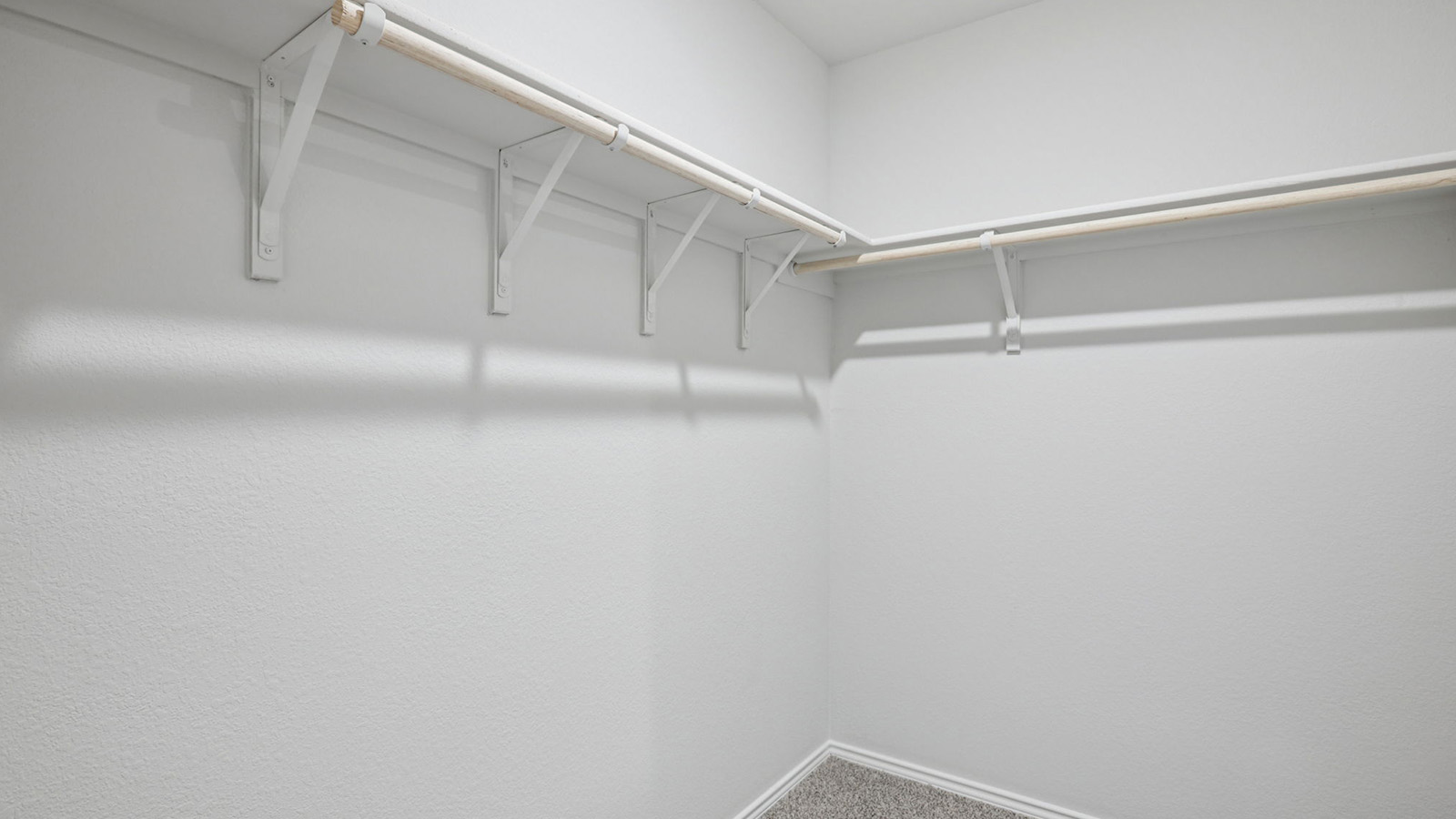 156 Wyatt Way Jarrell, TX 76537 - Photo 21 of 30 Walk-in closet featuring white walls, gray carpet, and a two-tiered hanging system with integrated shelving