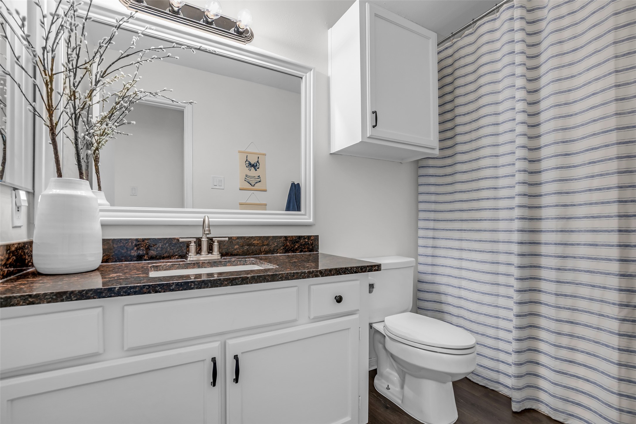 62 April Point Drive North Conroe, TX 77356 - Photo 22 of 25 a bathroom with a granite countertop toilet a sink and mirror