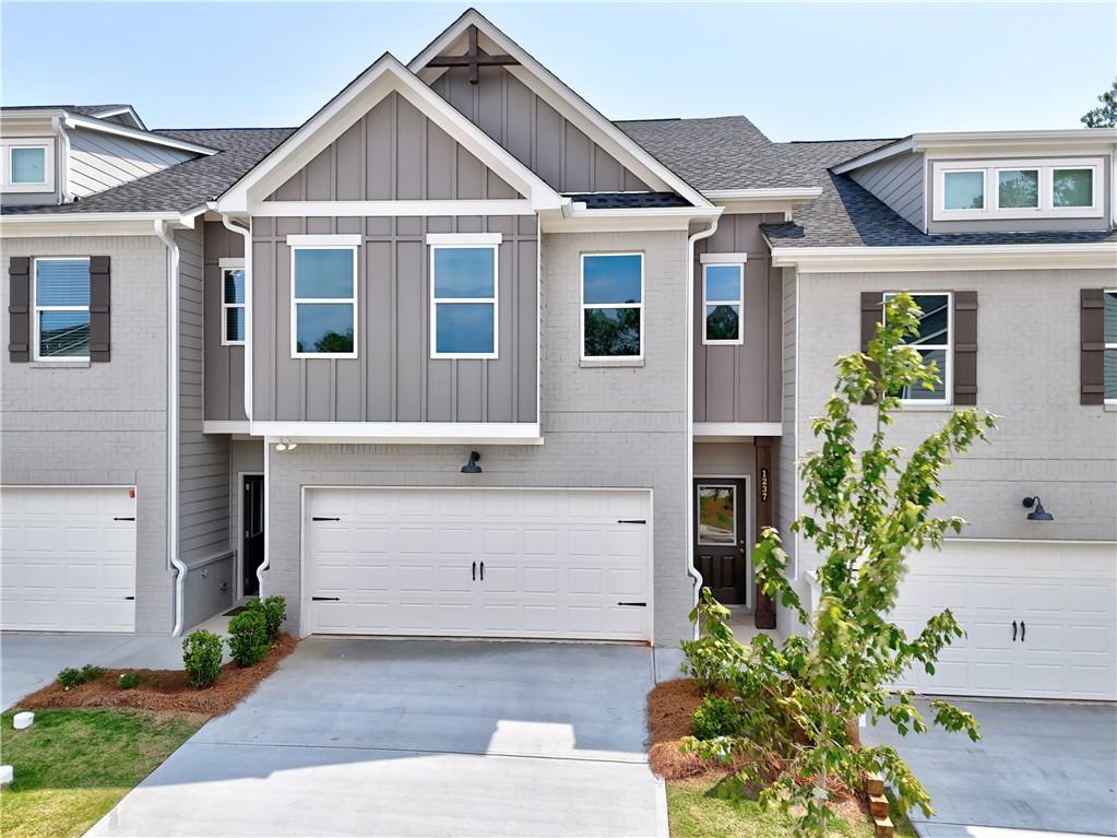 1237 Fern Rdg Lane, Unit 18 Norcross, GA 30093 - Photo 1 of 1 a front view of a house with a garden