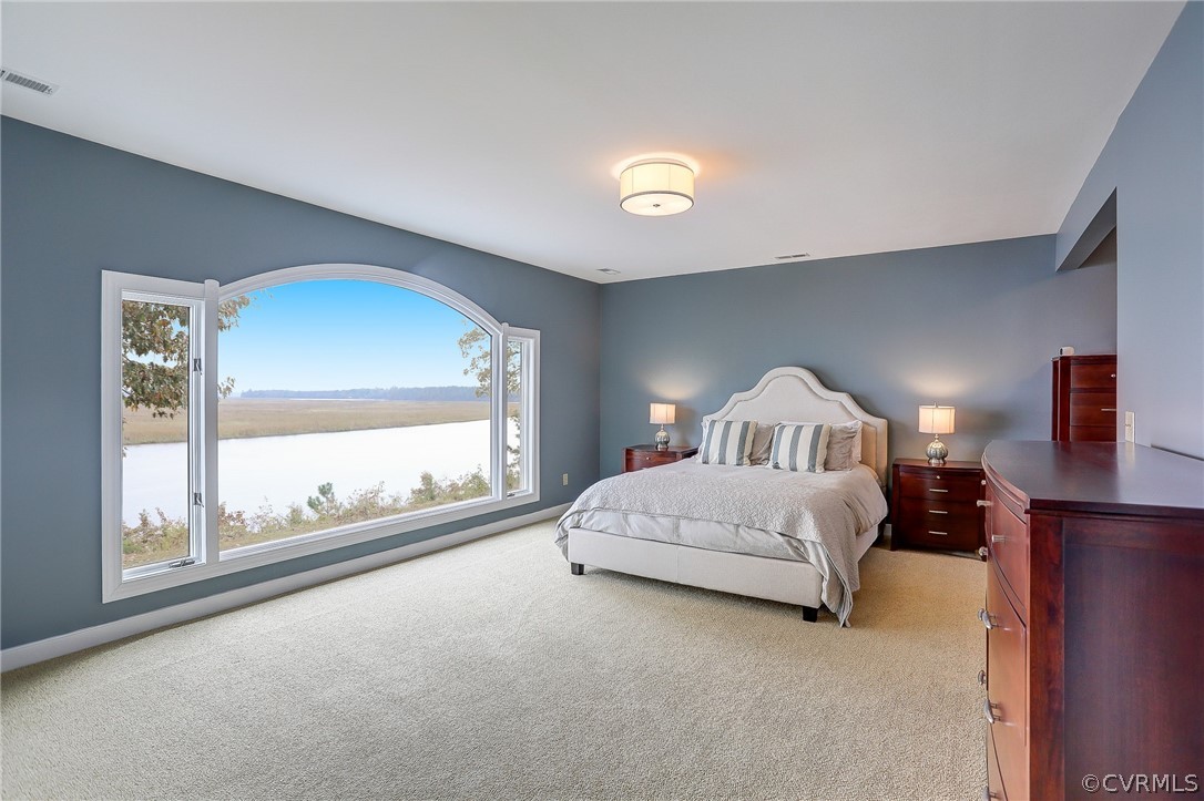 5149 Wakema Road West Point, VA 23181 - Photo 30 of 47 a spacious bedroom with a bed and a large window