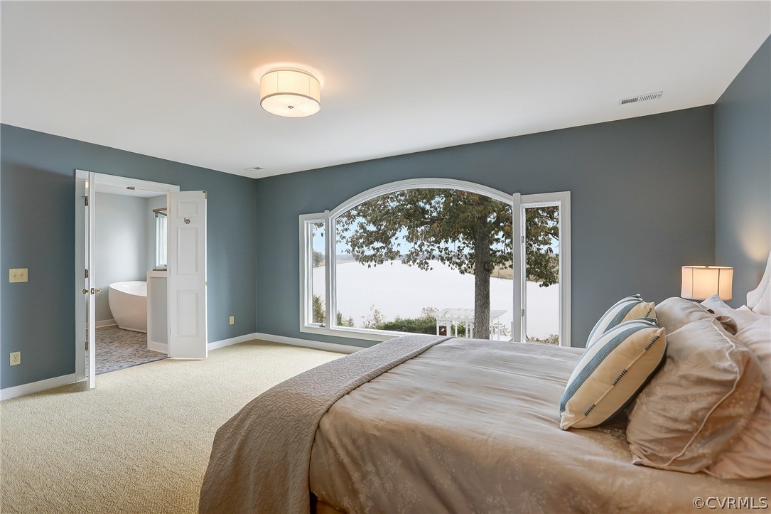 5149 Wakema Road West Point, VA 23181 - Photo 3 of 47 a bedroom with a large bed and a large window