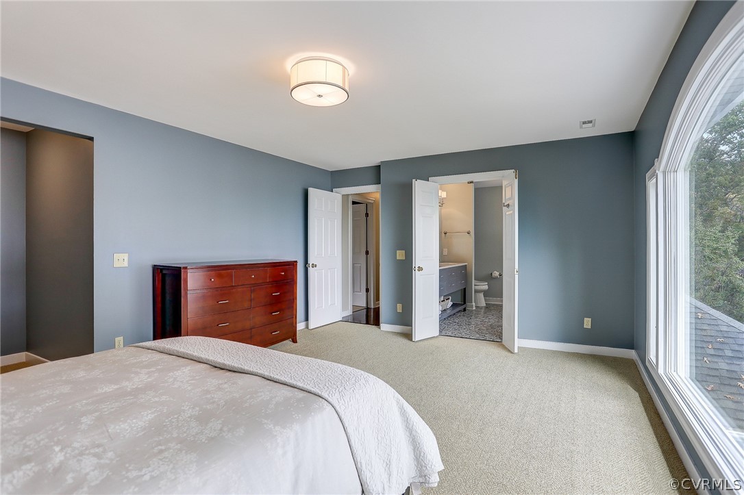 5149 Wakema Road West Point, VA 23181 - Photo 31 of 47 a bedroom with a large bed and chandelier