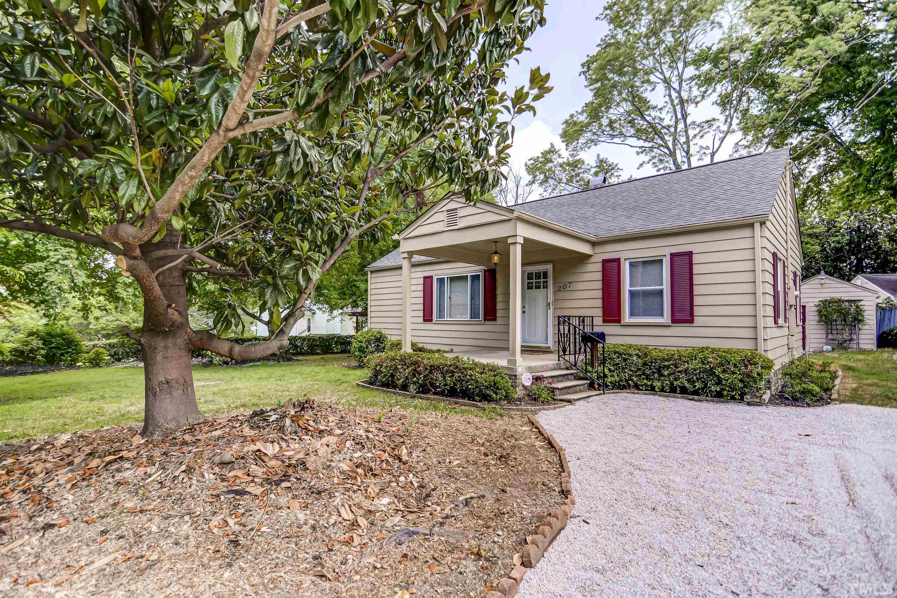 207 Myers Avenue Raleigh, NC 27604 - Photo 1 of 26 a front view of a house with a yard and trees