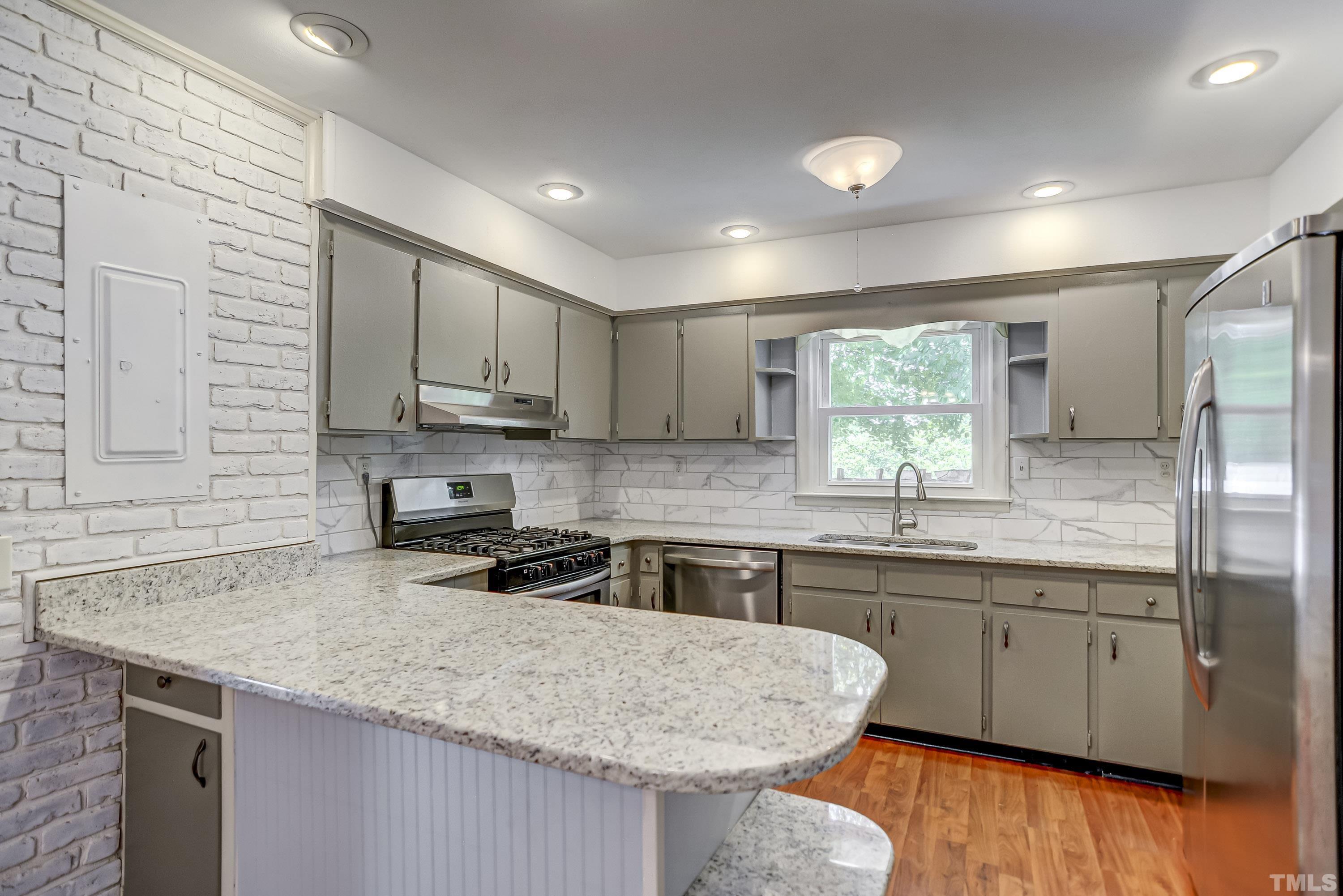 207 Myers Avenue Raleigh, NC 27604 - Photo 11 of 26 a kitchen with stainless steel appliances granite countertop a sink stove and cabinets