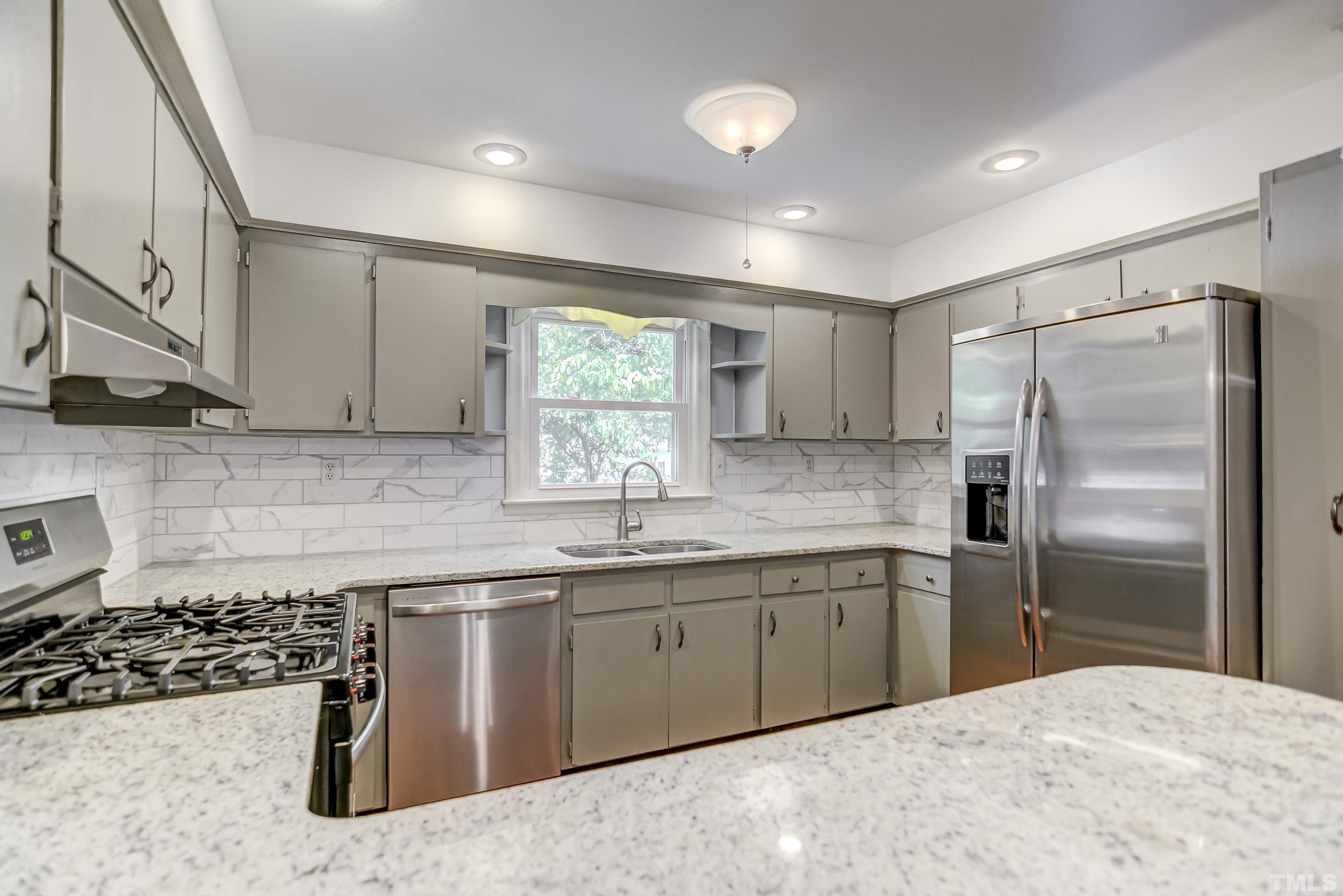 207 Myers Avenue Raleigh, NC 27604 - Photo 12 of 26 a kitchen with stainless steel appliances a sink stove and refrigerator