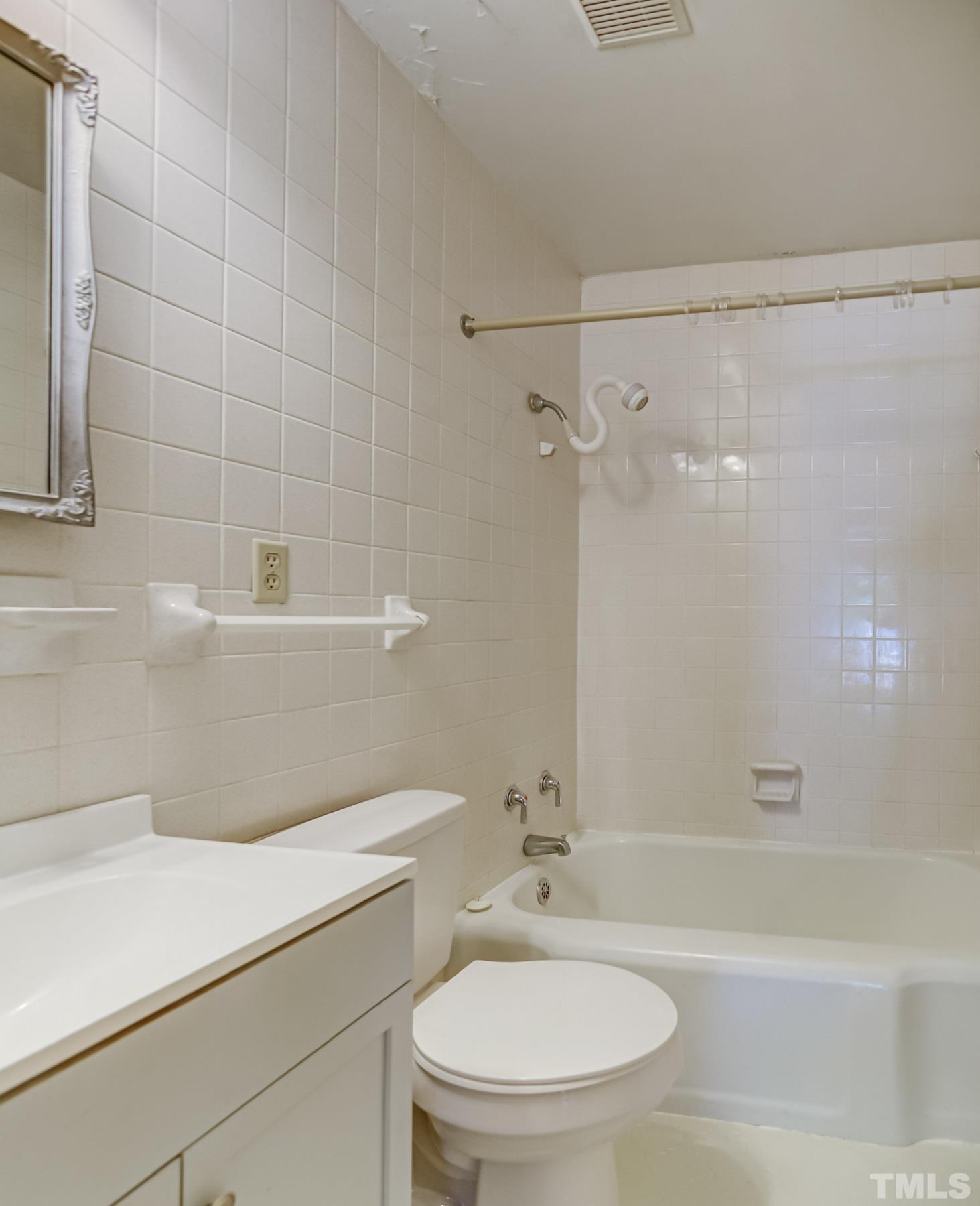 207 Myers Avenue Raleigh, NC 27604 - Photo 19 of 26 a bathroom with a sink a toilet and shower