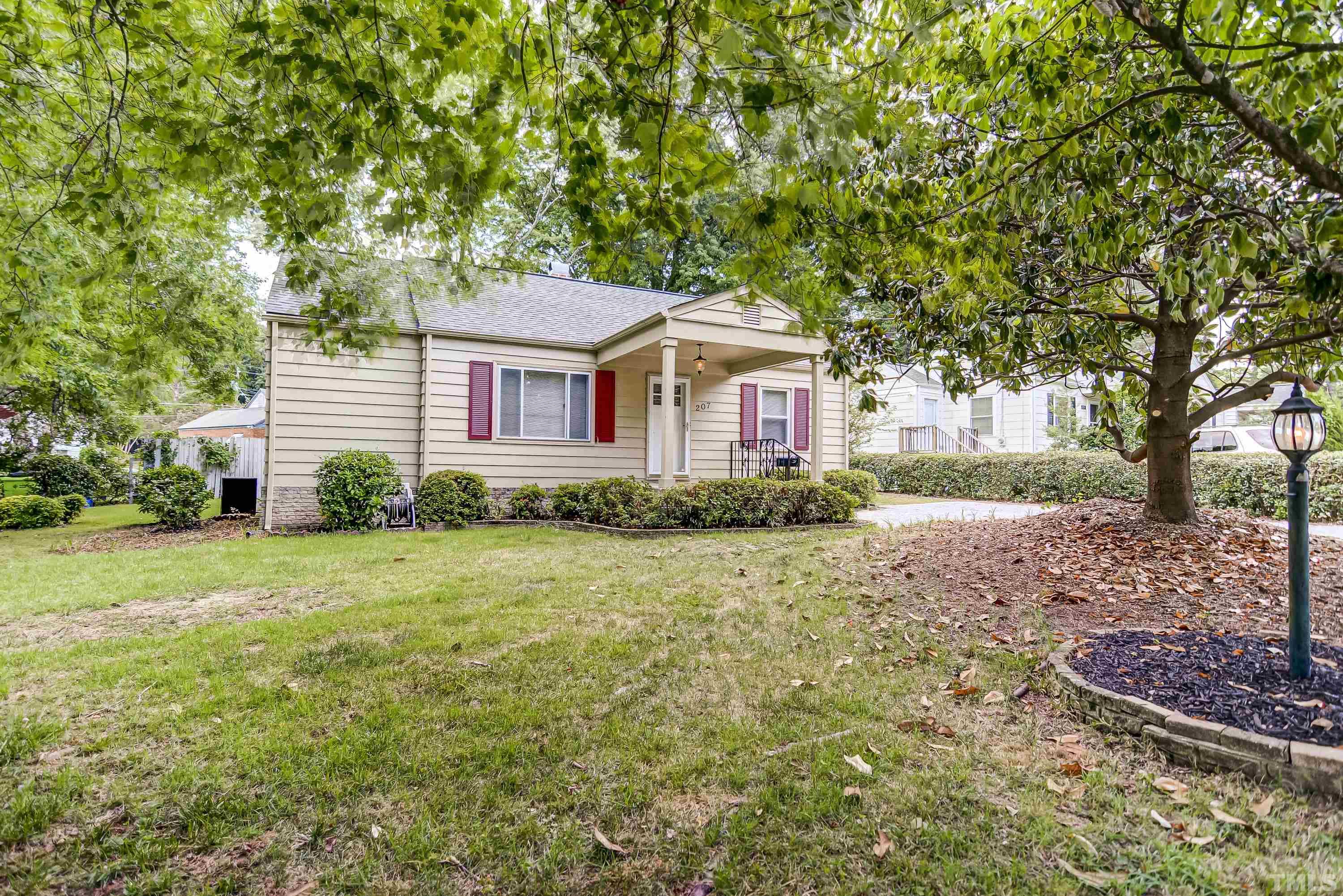 207 Myers Avenue Raleigh, NC 27604 - Photo 2 of 26 a front view of a house with a garden