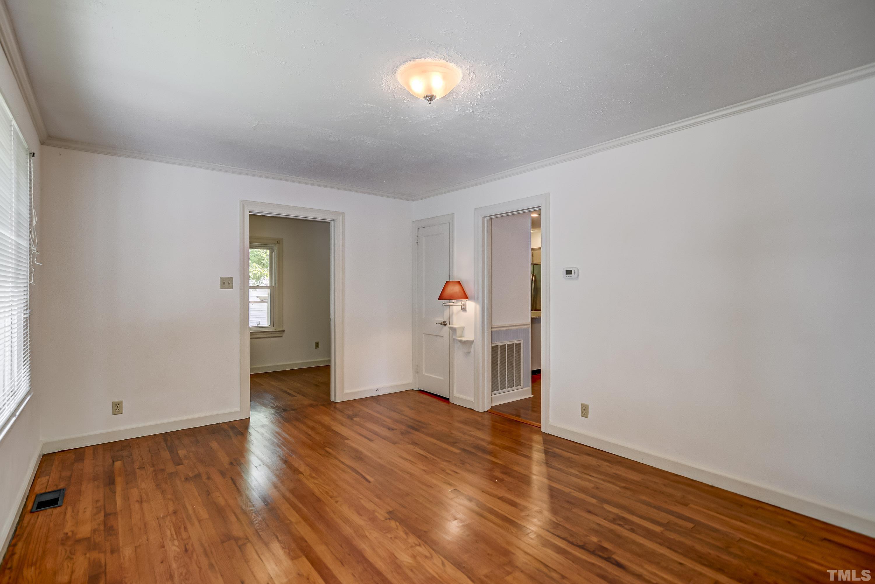 207 Myers Avenue Raleigh, NC 27604 - Photo 6 of 26 wooden floor in an empty room with a window