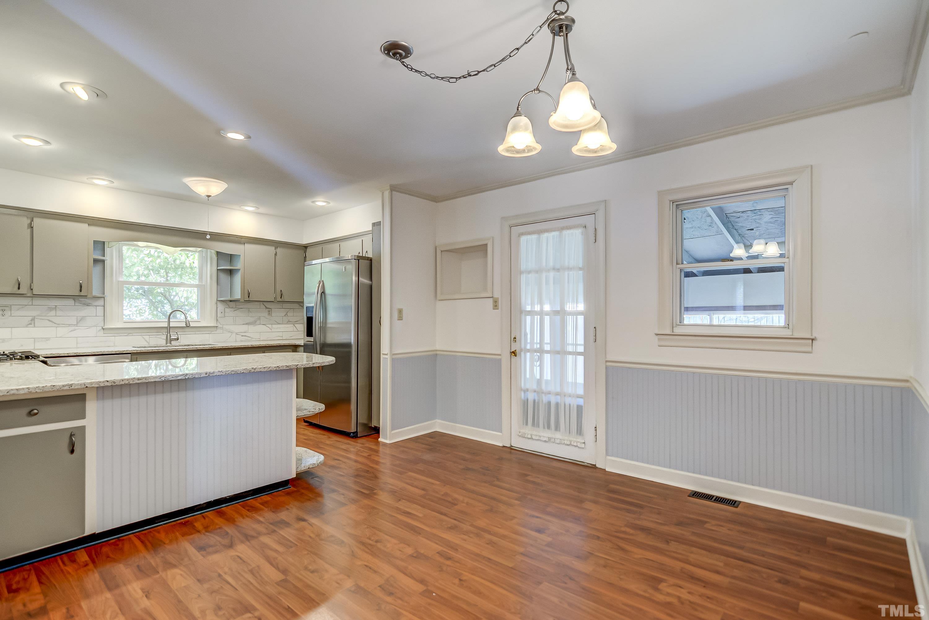 207 Myers Avenue Raleigh, NC 27604 - Photo 10 of 26 a large kitchen with stainless steel appliances granite countertop a refrigerator and a stove top oven