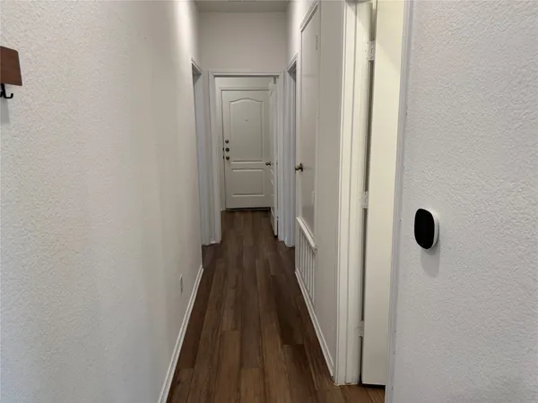a spacious kitchen with wooden floors and stainless steel appliances