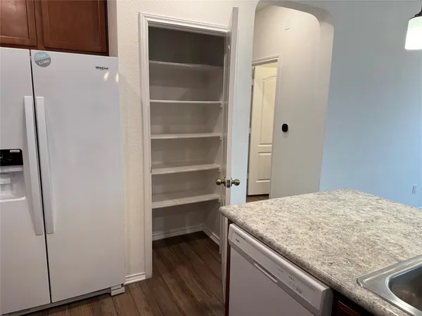 a kitchen with a stove a refrigerator and a sink