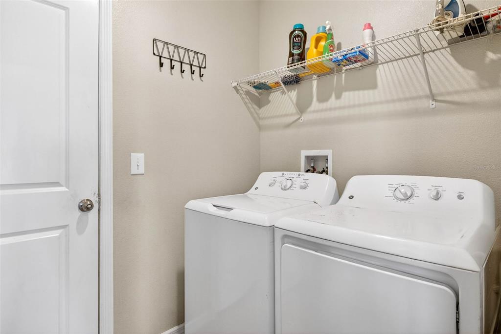 9616 Lemon Drop Loop Sun City Center, FL 33573 - Photo 27 of 53 a utility room with dryer and washer