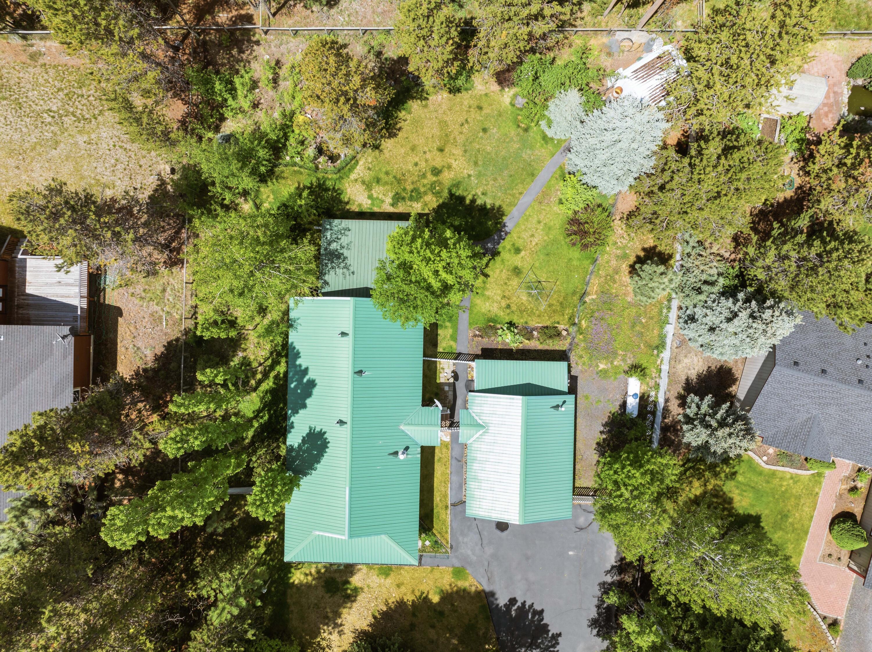 55885 Osprey Road Bend, OR 97707 - Photo 50 of 58 Aerial View of the homes and detached garages metal roof.