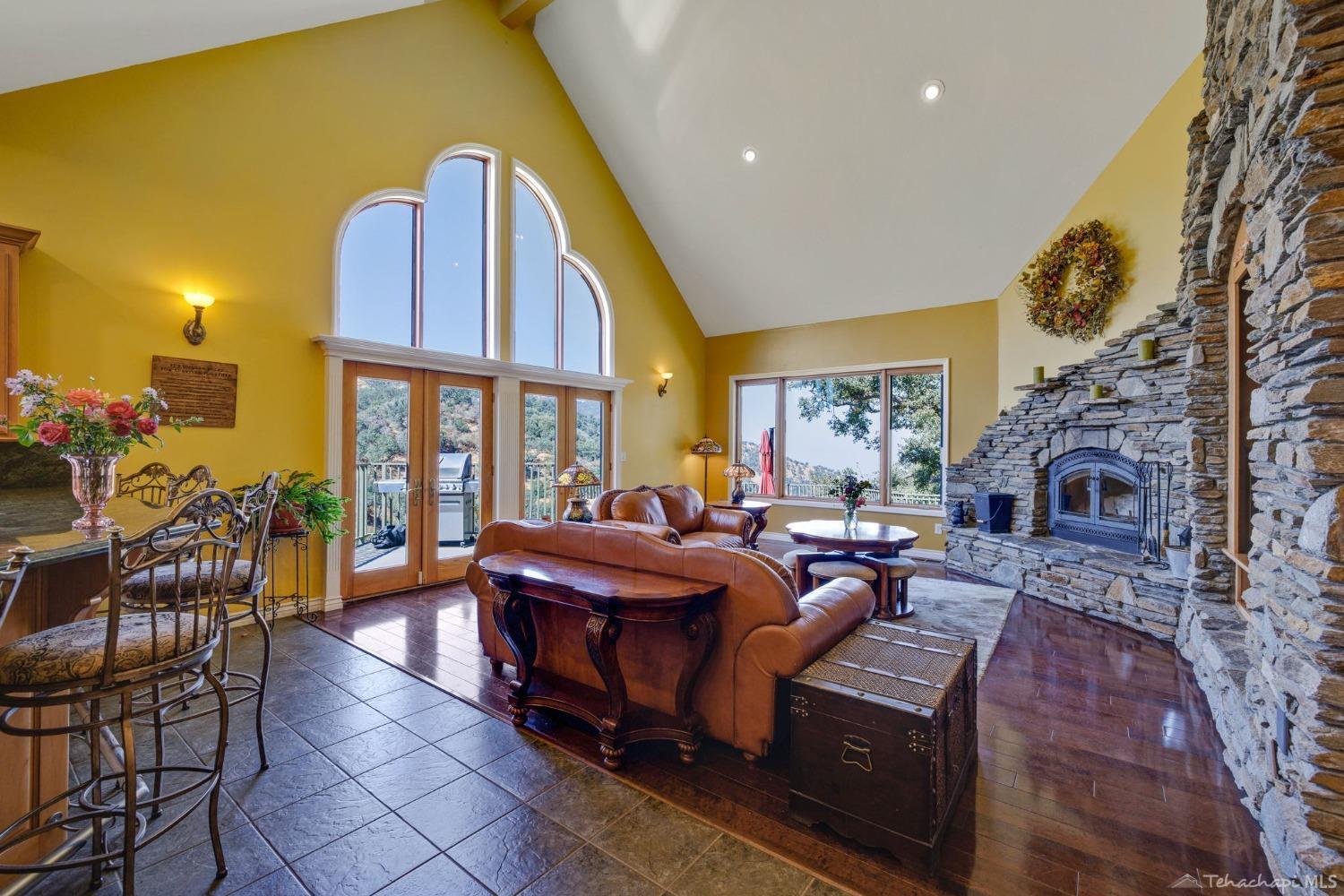 24500 Heather Court Tehachapi, CA 93561 - Photo 13 of 60 a living room with fireplace furniture and a large window