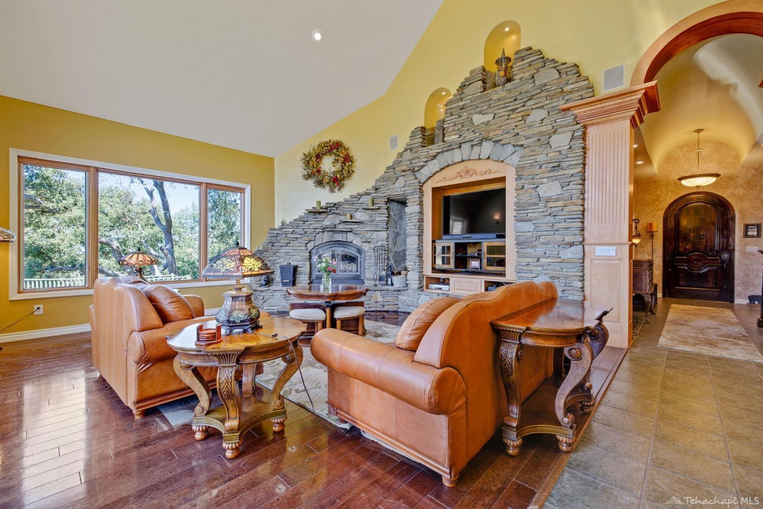 24500 Heather Court Tehachapi, CA 93561 - Photo 15 of 60 a living room with fireplace furniture and a large window