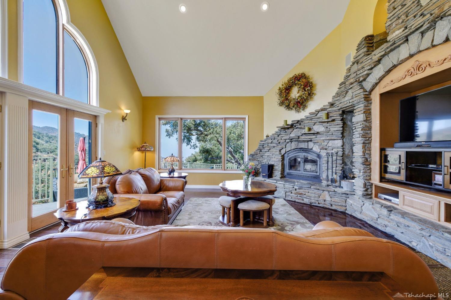 24500 Heather Court Tehachapi, CA 93561 - Photo 16 of 60 a living room with furniture fireplace and a large window