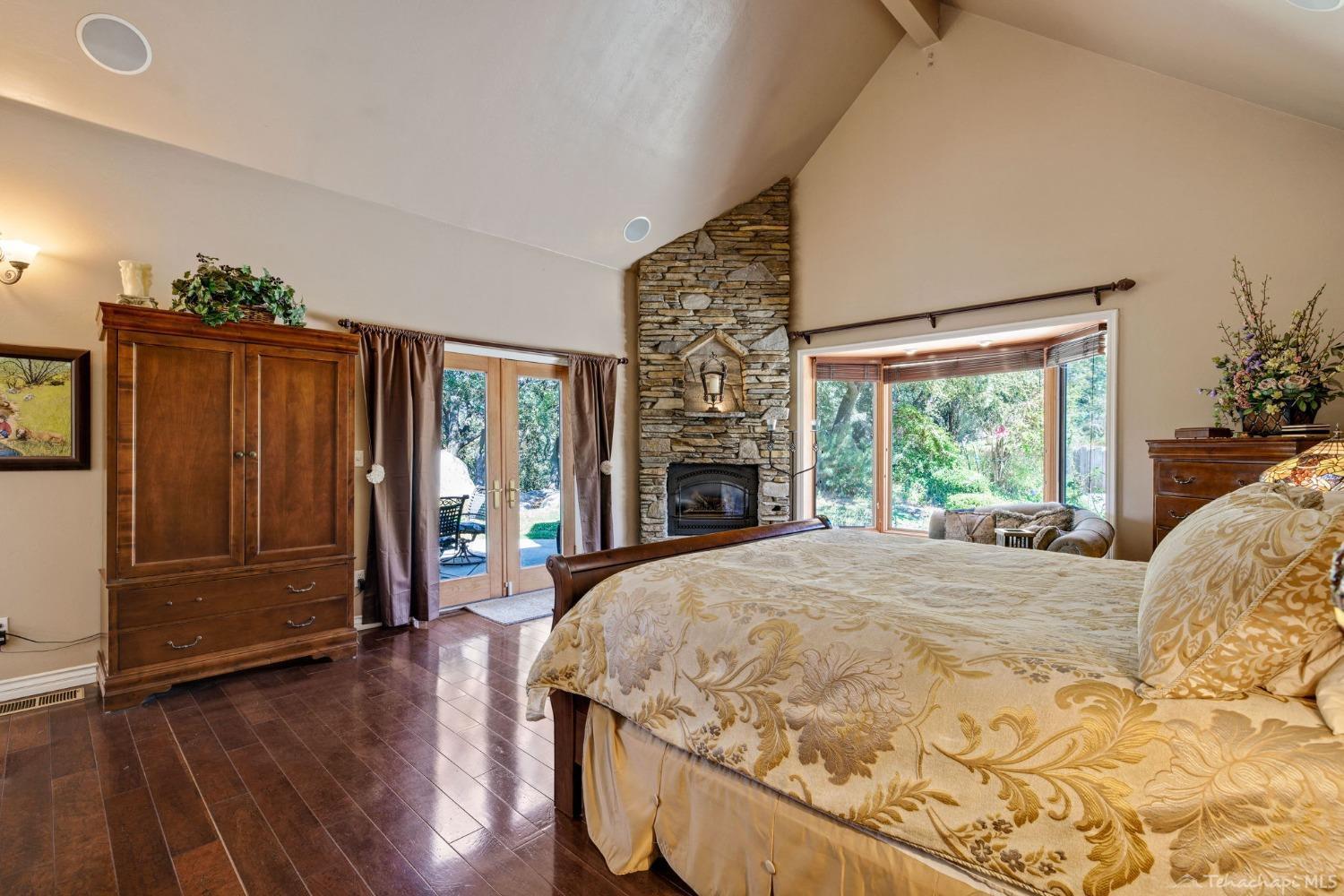 24500 Heather Court Tehachapi, CA 93561 - Photo 23 of 60 a bed sitting in a bedroom next to a window
