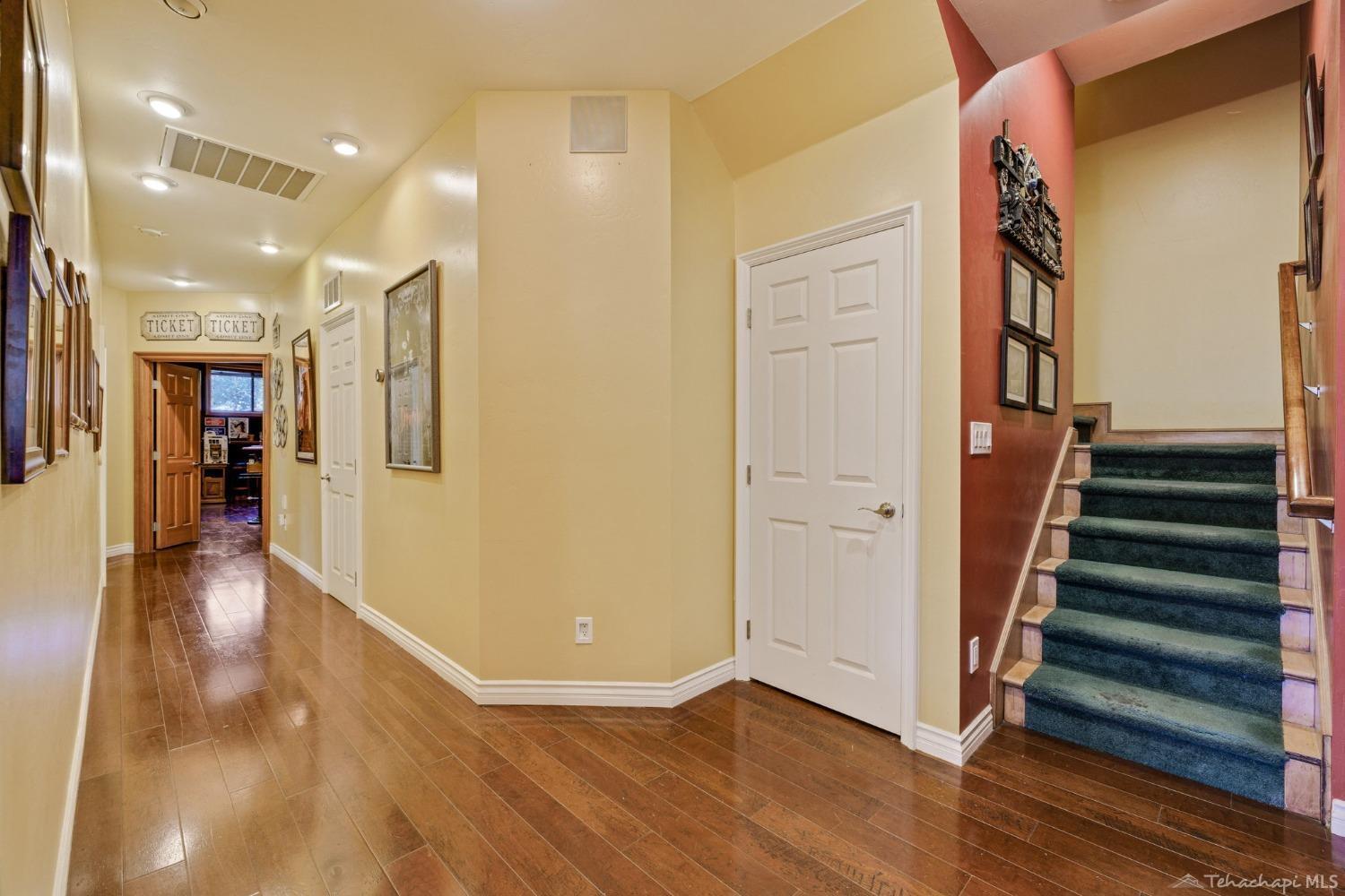 24500 Heather Court Tehachapi, CA 93561 - Photo 29 of 60 a view of a hallway with wooden floor and staircase