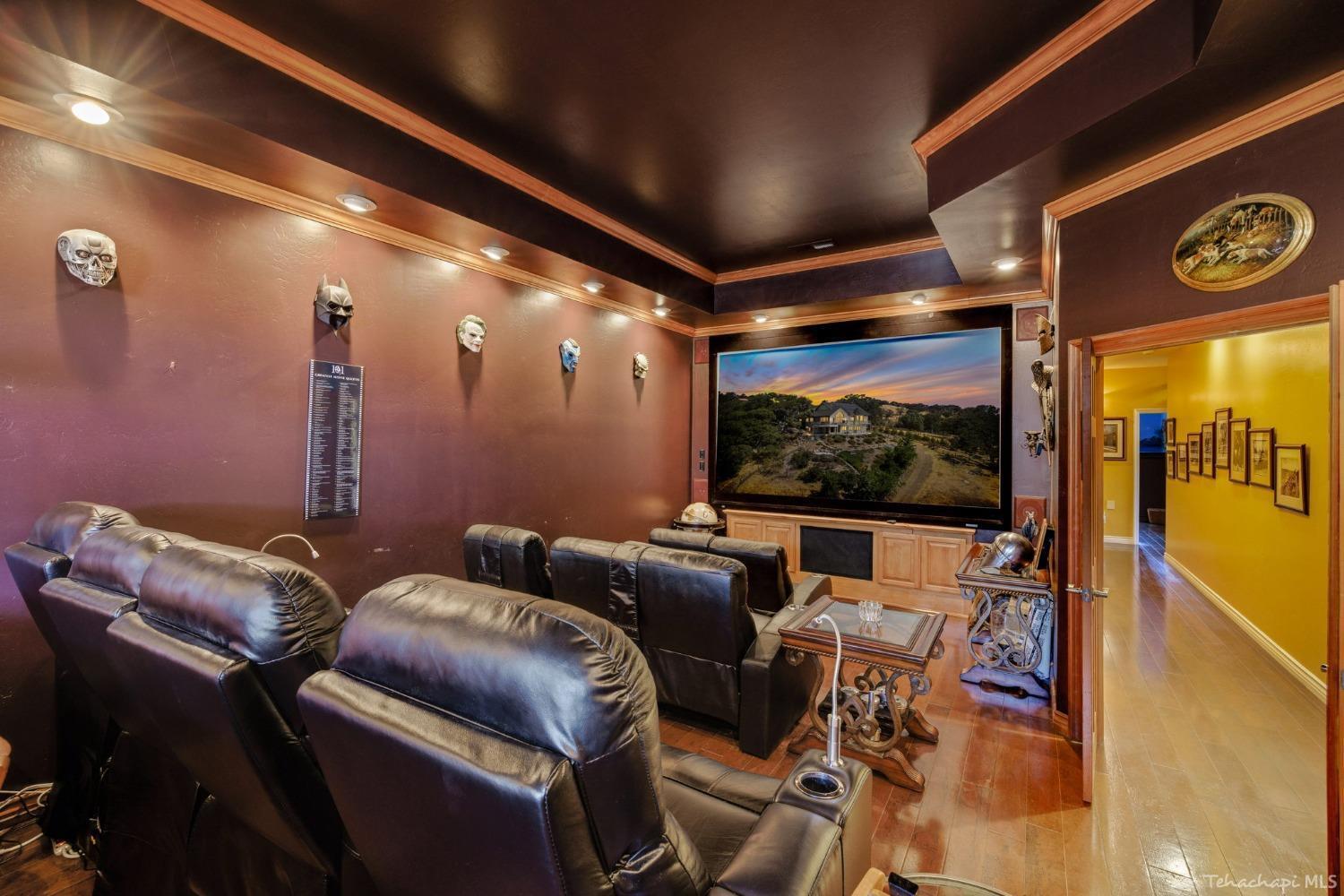 24500 Heather Court Tehachapi, CA 93561 - Photo 31 of 60 a media room with lots of chairs and a projector screen