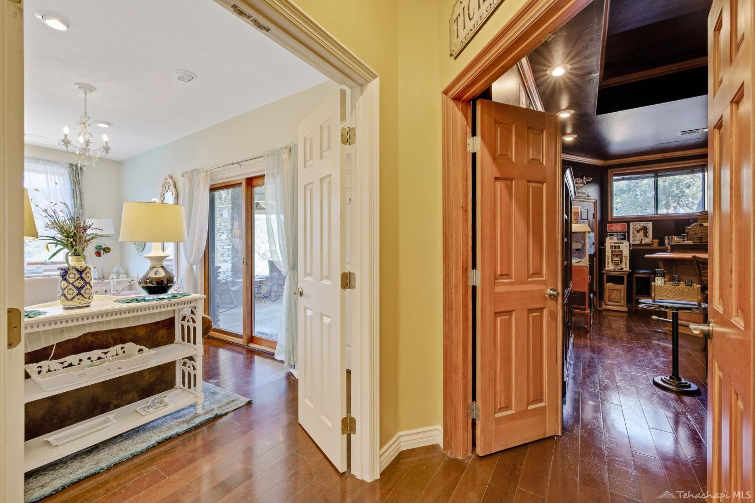 24500 Heather Court Tehachapi, CA 93561 - Photo 32 of 60 a view of a hallway with wooden floor and furniture