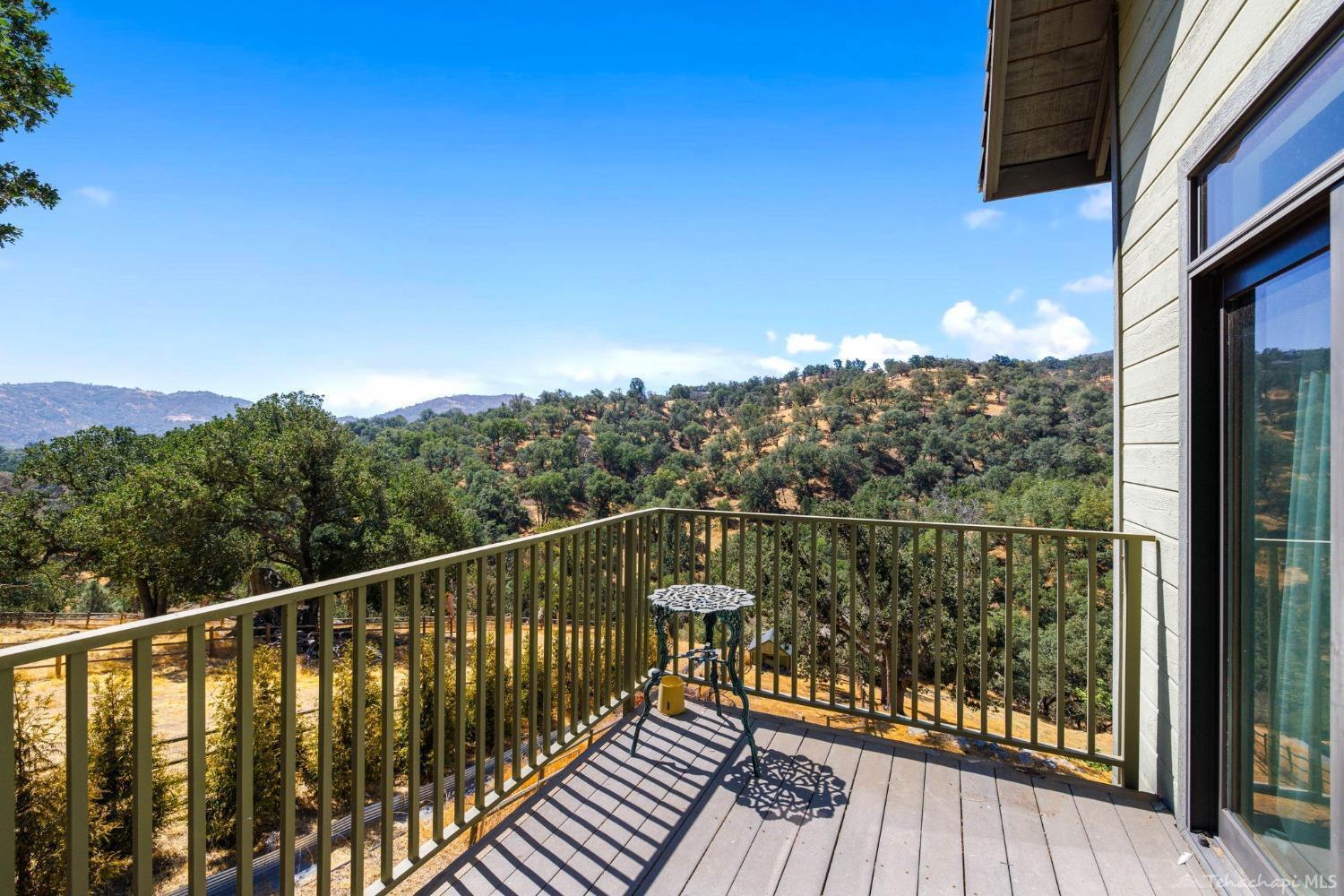 24500 Heather Court Tehachapi, CA 93561 - Photo 40 of 60 a view of a balcony with wooden floor and fence