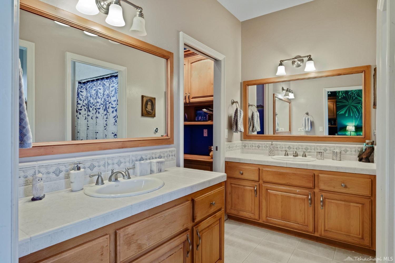 24500 Heather Court Tehachapi, CA 93561 - Photo 45 of 60 a bathroom with a sink and a mirror