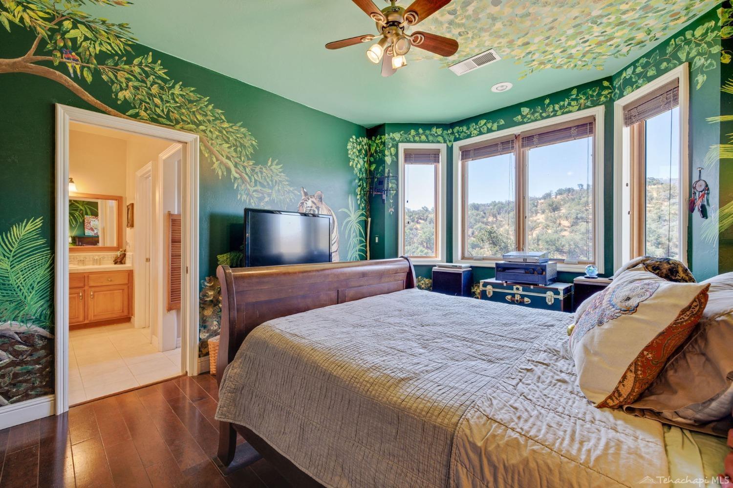 24500 Heather Court Tehachapi, CA 93561 - Photo 46 of 60 a bedroom with a bed and a chandelier